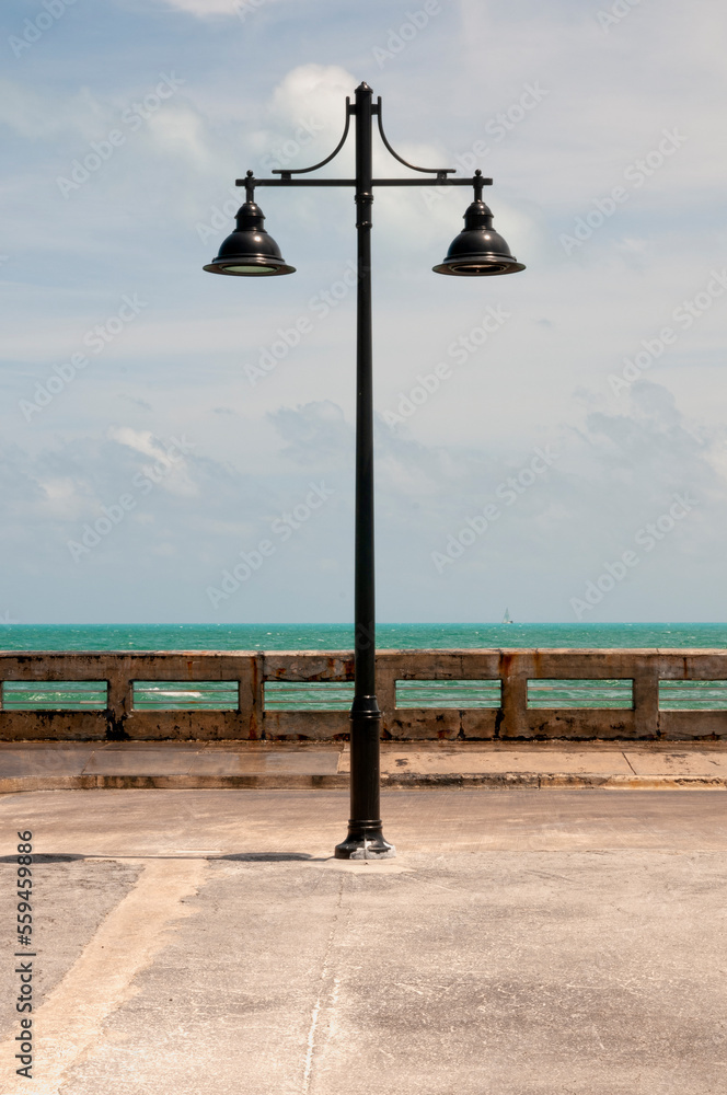 Streetlight in a pier against the blue sky in Key West Florida. Vertical Screen