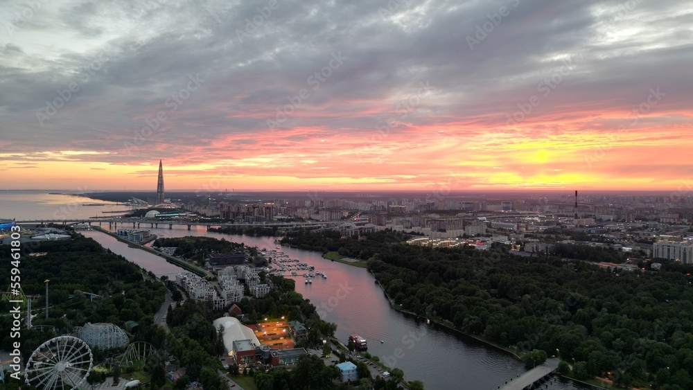 Amazing sunset view over the river in a European city. Drone view