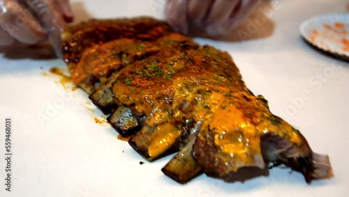 Peeling meat from spare ribs barbeque with cheese sauce