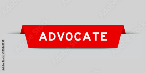 Red color inserted label with word advocate on gray background