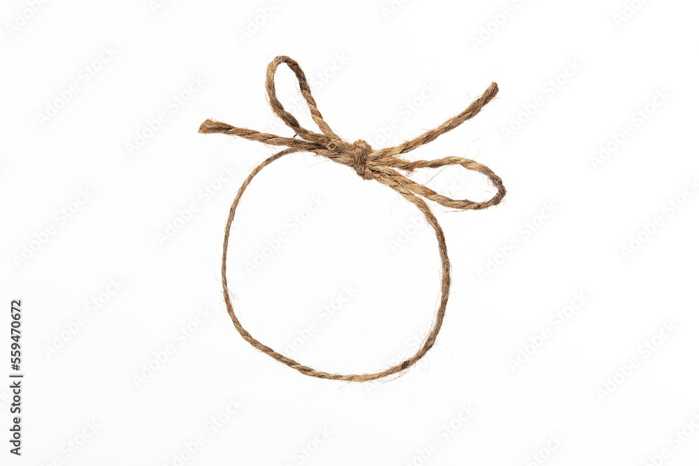 String twine rope bow isolated on white, jute string closed loop, natural fiber brown thread