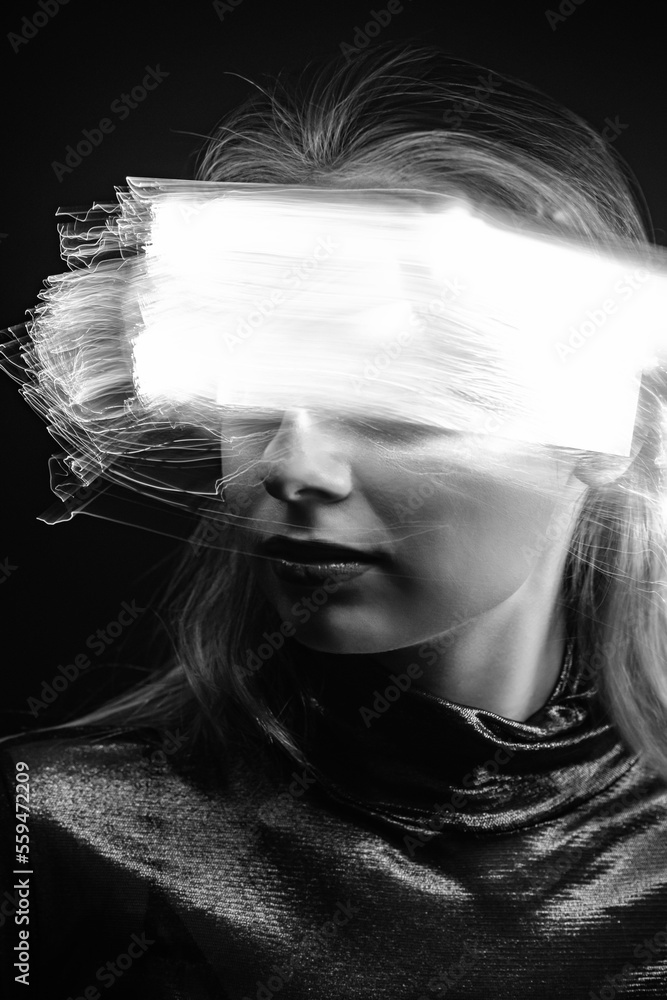 Face silhouette in bright light trails of light painting only visible