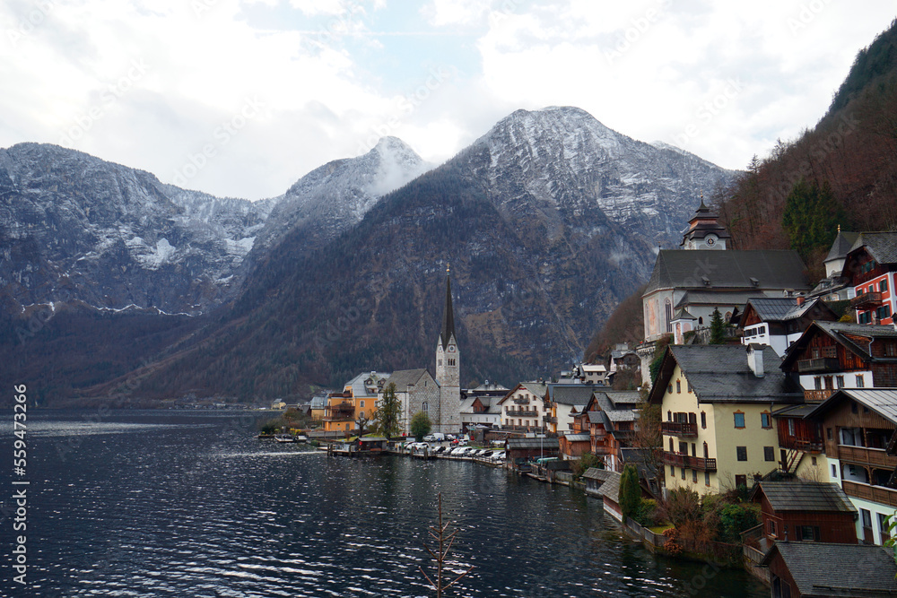 Stunning view of the Hallstatt village surrounded by mountains and beautiful nature in winter.