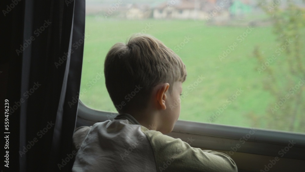 Little boy watching on train window during travelling in vacation Little boy watching on train window during travelling in vacation