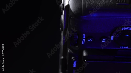 Mogilev, Belarus - January 4, 2023: Sony Alpha fx30 Mirrorless Digital Camera Case. Sony Slow Rotating Camera. Sony alpha camera Rotate camera on table on black background with blue and gray lighting. photo