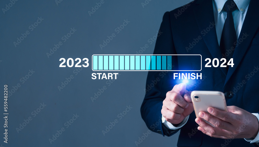 On New Year's Eve, a businessman taps a virtual download bar with a ...