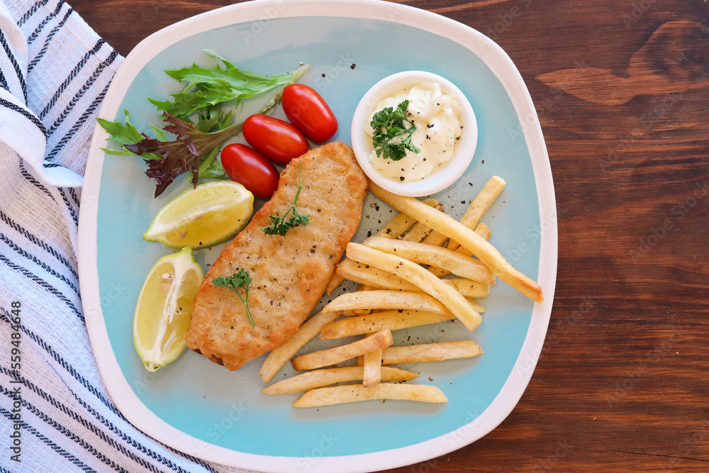 grilled fish fillet with chips and salad. Hake with hot chips