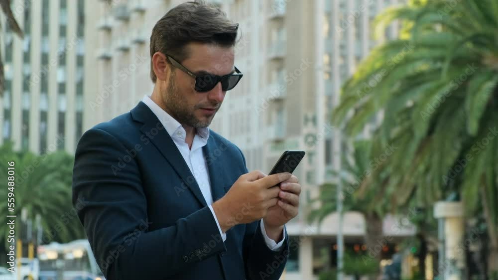 businessman extremely happy after read message in mobile phone Excited employee looking at screen and pleased rejoices received great news on smartphone. entrepreneur celebrating business success businessman extremely happy after read message in mobile phone Excited employee looking at screen and pleased rejoices received great news on smartphone. entrepreneur celebrating business success