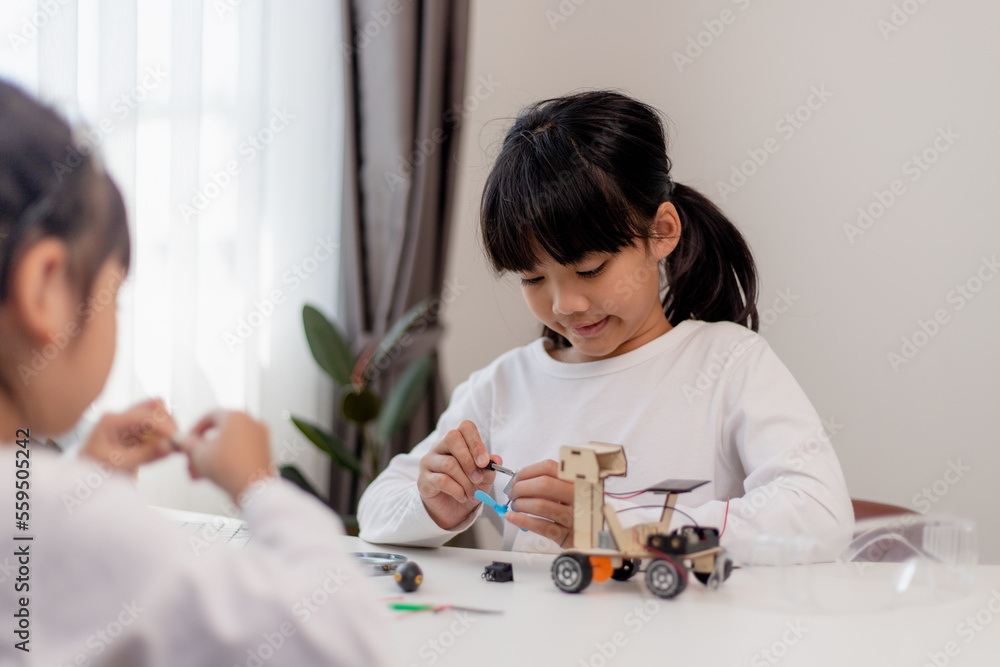 Asia students learn at home in coding robot cars and electronic board cables in STEM, STEAM, mathematics engineering science technology computer code in robotics for kids concept. Asia students learn at home in coding robot cars and electronic board cables in STEM, STEAM, mathematics engineering science technology computer code in robotics for kids concept.
