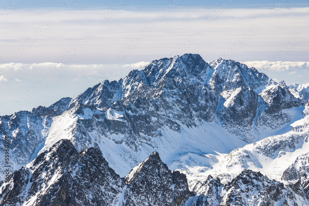Snowy winter high mountain landscape. A panoramic view from the top of The Lomnicky peak in High Tatras National Park, Slovakia, Europe.