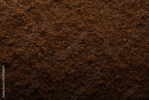 Cup of coffe and brown coffee surface texture background.