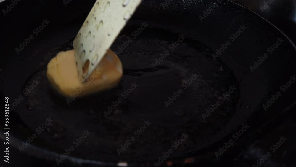 Putting butter on frying pan on gas stove in modern kitchen, slow motion. High quality 4k footage Putting butter on frying pan on gas stove in modern kitchen, slow motion. High quality 4k footage