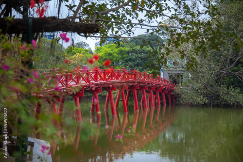 red bridge in the garden over the lake (The Huc bridge to Ngoc Son temple) photo