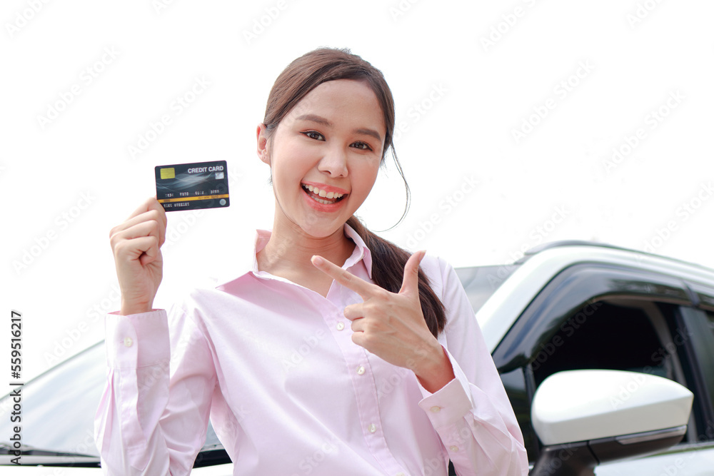 Beautiful Asian woman office worker getting a new car Holding a credit card, she smiles happily. Cash card concept. car insurance Beautiful Asian woman office worker getting a new car Holding a credit card, she smiles happily. Cash card concept. car insurance