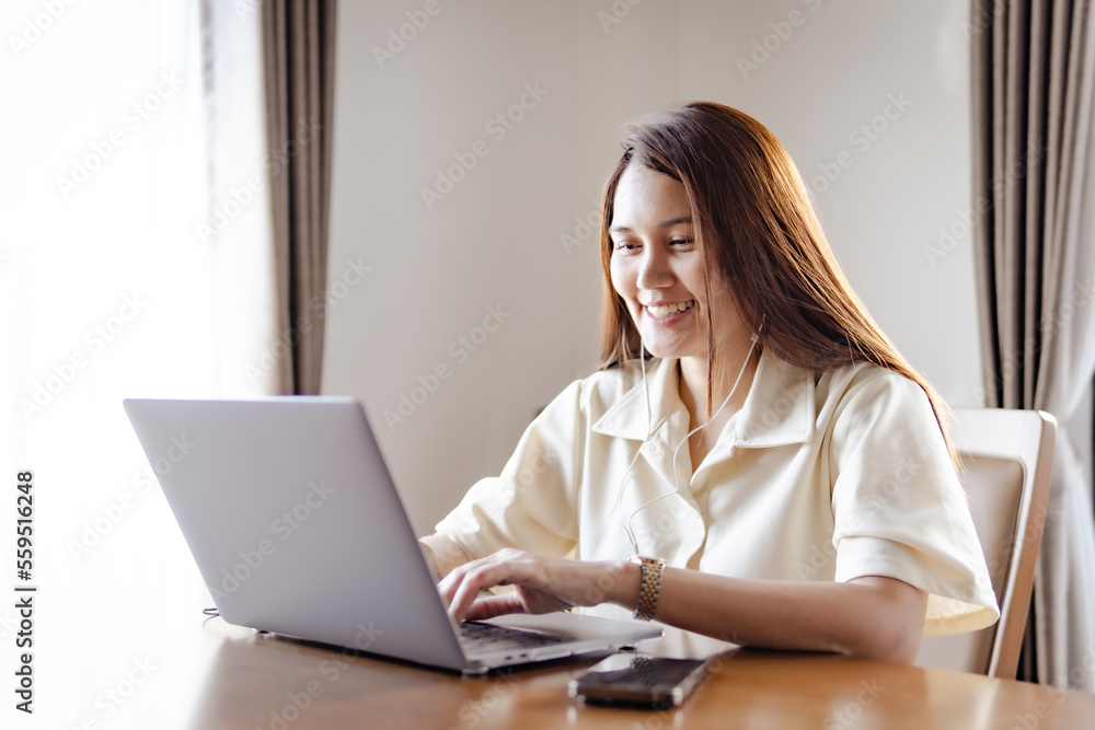 Asia young beautiful joyful woman smiling while working with laptop. Asia young beautiful joyful woman smiling while working with laptop.