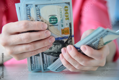 Close up of woman hands counting dollars