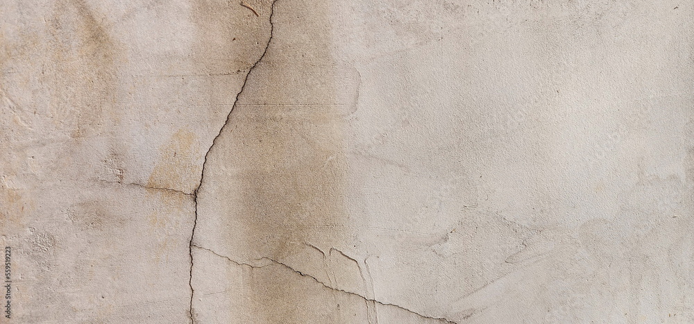 Naklejka premium The old cement wall cracked until a long crevice was visible. It may be caused by improper mixing of mortar or soil subsidence. This may cause some concern for users.