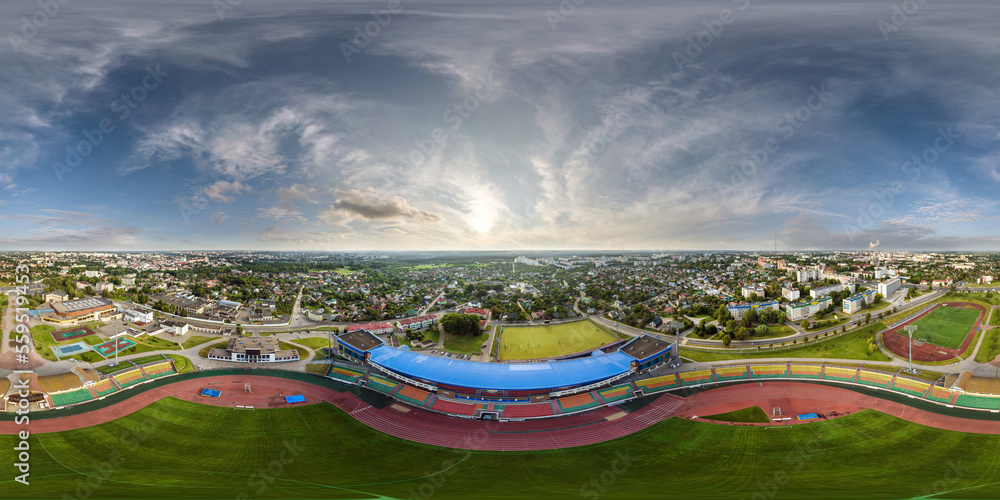 aerial 360 hdri panorama view from above on empty stadium or sports complex in equirectangular seamless spherical projection, ready for use as sky replacement in drone 360 panoramas