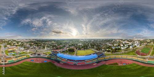 aerial 360 hdri panorama view from above on empty stadium or sports complex in equirectangular seamless spherical projection  ready for use as sky replacement in drone 360 panoramas