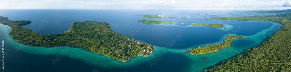 A scenic tropical island is fringed by a coral reef in the Solomon ...