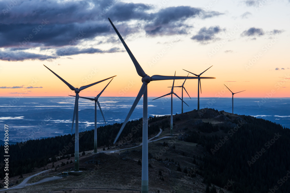 A group of wind power plants early in the morning while sunrise in Austria A group of wind power plants early in the morning while sunrise in Austria