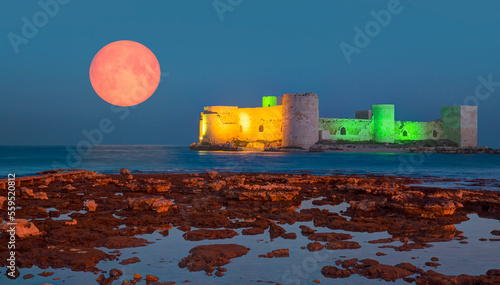 Super bloody red moon over The Maiden's Castle at dusk (Kiz kalesi) - Mersin -Turkey "Elements of this image furnished by NASA " 