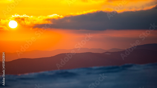 panorama of snowy mountains bieszczady at sunset  coniferous trees covered with snow  colorful winter sunset seen from the top of the mountain bukowe berdo
