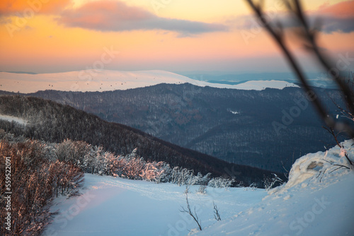 Fototapeta Naklejka Na Ścianę i Meble -  panorama of snow-capped mountains bieszczady at sunset, winter sunset seen from the top of the mountain wielka rawka