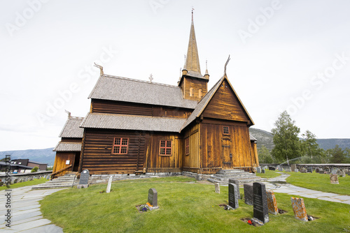 A beautiful wooden stave church in Norway with a cemetery around