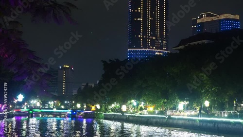 A boat sailing on the kalimas river in Surabaya at night. Night shot. photo