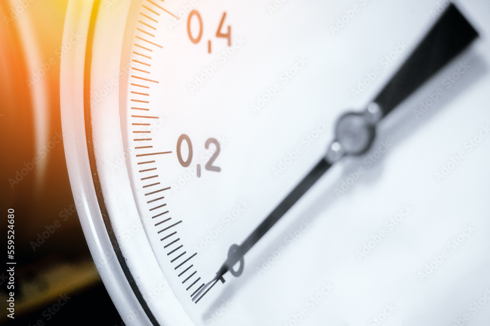 Pressure gauge closeup. Arrow of pressure gauge shows zero on scale