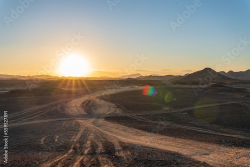 sunset over the mountains in the middle of the african desert photo