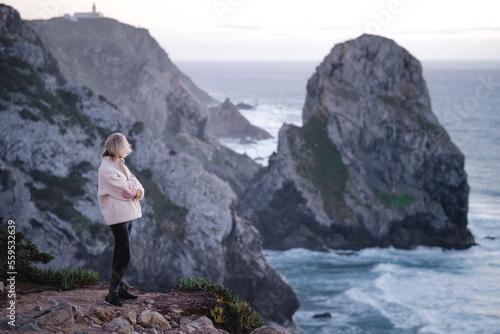Woman on the Atlantic cliffs near Sintra, Portugal.