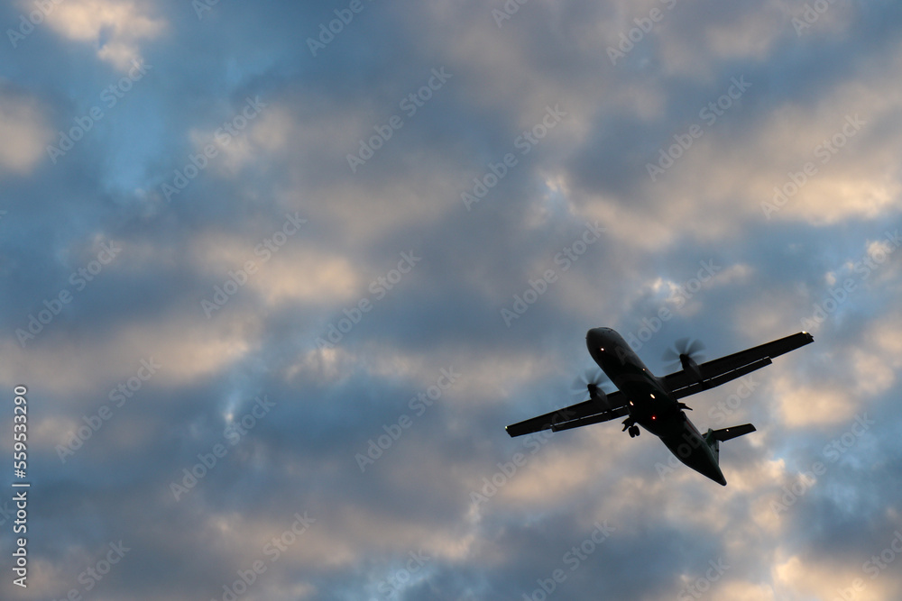 airplane in the sky at sunset