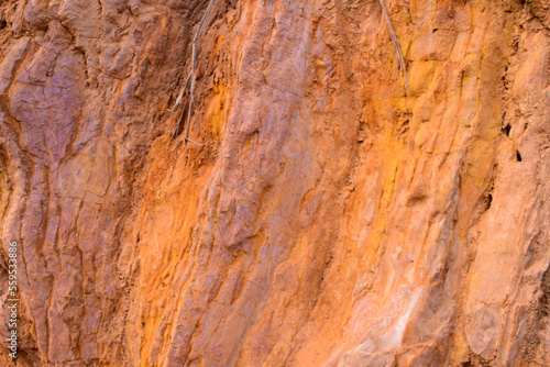 Closeup of the multicolored pink rock wall background and texture with detailed