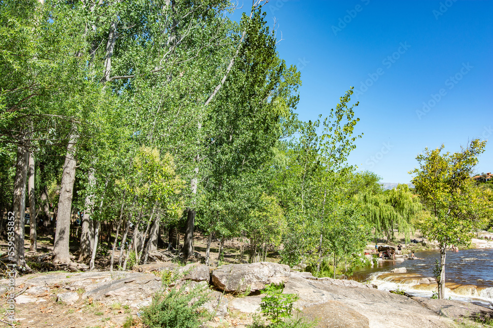 Fototapeta premium Extraordinary nature of the province of Cordoba Argentina in the city of Mina Clavero and people resting on the river