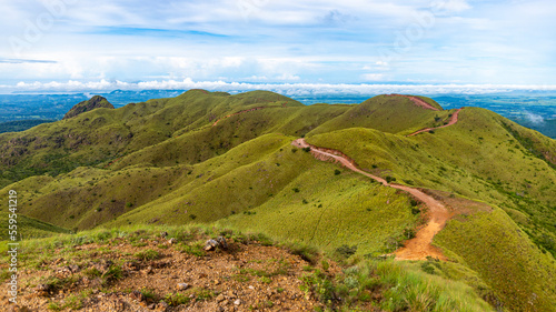 panorama of Costa Rica's cerro pelado mountains during a sunny day; mighty mountains covered with green, succulent grass; mountains in the tropics amidst rainforests