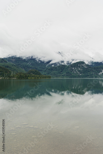 Picturesque view of lake with mountains and clouds reflections. Scenic nature landscape. Summer vacation travel in national park