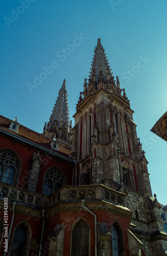 Gothic architecture of the Catholic cathedral. Part of the Catholic cathedral on the background of the blue sky. Church of St. Nicholas