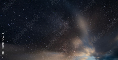 Beautiful long exposure night sky with clouds and stars . Starry sky background.