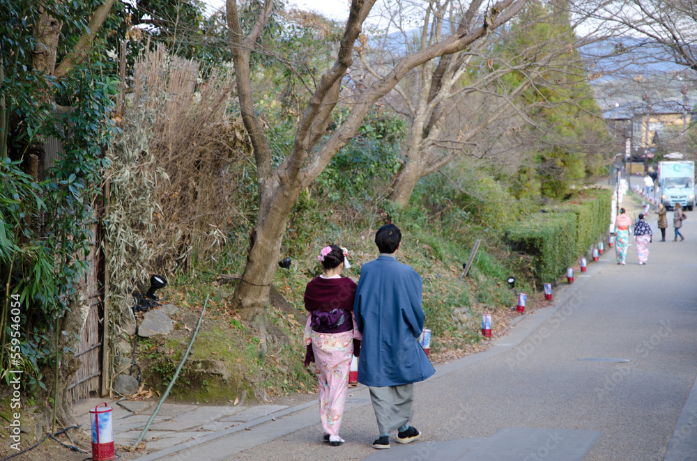 Japanese couple in traditional costume walking. Arashiyama. Kyoto. Japan.