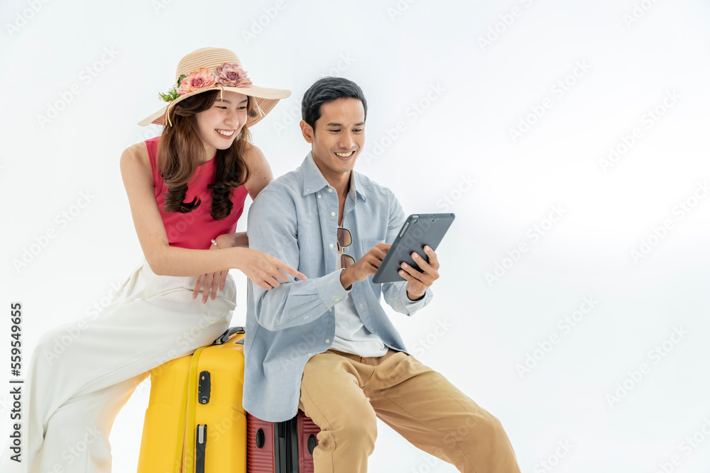Portrait of an Asian couple with their suitcases, passports and travel tickets. isolated on a white background