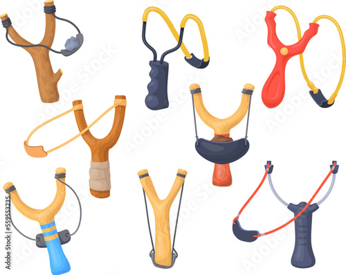 Slingshots. Wooden kid slingshot or catapult wood stick with elastic sling and stone, homemade weapon child game, shot tools childhood