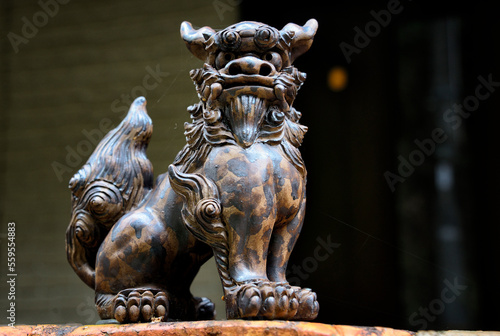Kyoto, Japan, Asia - Guardian lion statue - Shisa at entrance to house, people place pairs of shisa at gates to protect their houses, left shisa with closed mouth keeps good spirits in