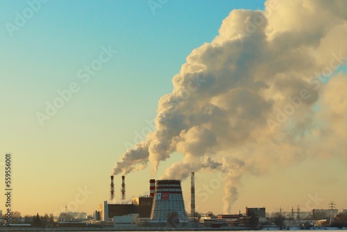 Winter clear cold morning, smoking chimneys of a power plant on the shore of a frozen lake © Ruslan