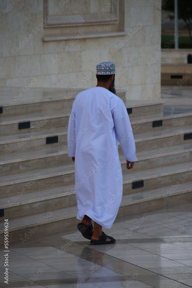 Man walking outside a mosque (Muscat, Oman)