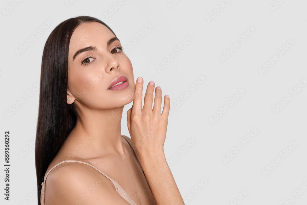 Portrait of attractive young woman on light grey background, space for text. Spa treatment Portrait of attractive young woman on light grey background, space for text. Spa treatment