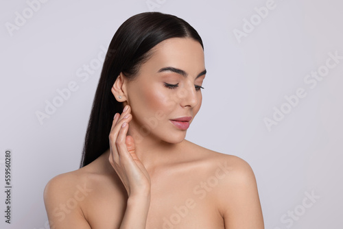 Portrait of attractive young woman on light grey background. Spa treatment