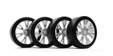 Four car tires with silver rims standing in row on white background