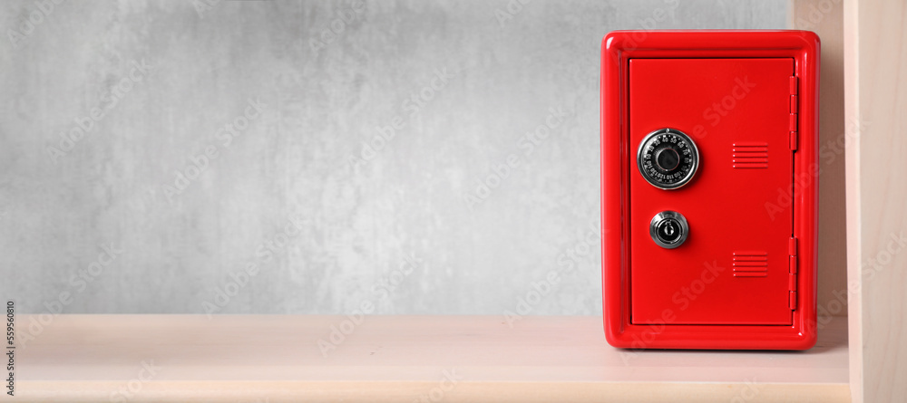 Red steel safe with mechanical combination lock on shelf, banner design. Space for text - obrazy, fototapety, plakaty 